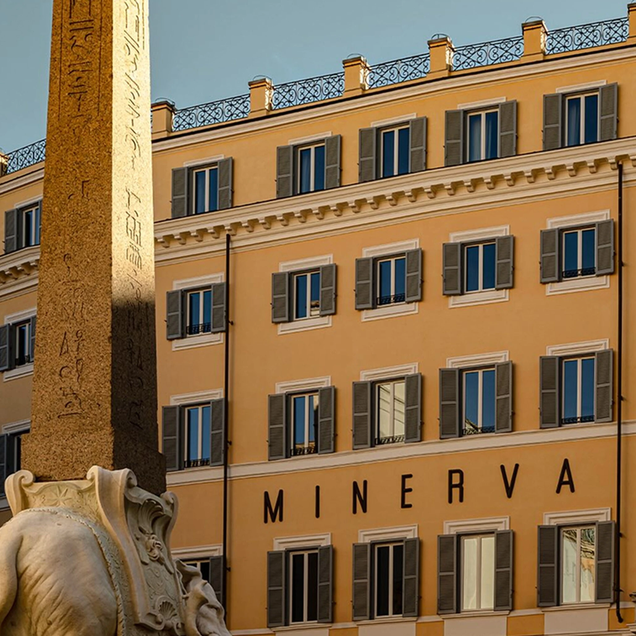 Hotel Minerva facade showing MINERVA lettering beside the elephant obelisk in Piazza della Minerva, Rome 